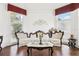 Cozy living room with ornate furniture set, hardwood flooring, and a large window providing natural light at 2747 Kissimmee Bay Cir, Kissimmee, FL 34744