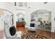 Open-concept living room with hardwood floors, arched doorways, and view of the kitchen at 2747 Kissimmee Bay Cir, Kissimmee, FL 34744