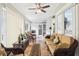 Inviting sun room featuring comfortable wicker furniture, ceiling fan and tile flooring at 2747 Kissimmee Bay Cir, Kissimmee, FL 34744