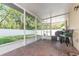 Screened patio with brick floor, white support pillars, ceiling and outdoor chairs and tables at 322 Lusitano Way, Sanford, FL 32773