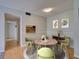 Inviting dining room with stylish decor, light wood floors, and a view to the kitchen at 3242 S Semoran Blvd # 21, Orlando, FL 32822