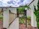Inviting exterior view of a charming two-story condo with landscaped yard and palm trees at 3242 S Semoran Blvd # 21, Orlando, FL 32822