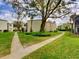 Landscaped condo grounds with mature trees and inviting sidewalks at 3242 S Semoran Blvd # 21, Orlando, FL 32822