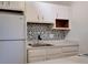 Kitchen view showing a white fridge, stainless steel sink, and mosaic backsplash at 3242 S Semoran Blvd # 21, Orlando, FL 32822