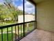 A screened patio showcasing tiled flooring with a view of the manicured yard at 3242 S Semoran Blvd # 21, Orlando, FL 32822