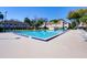 Community pool is surrounded by lounge chairs and shows residential buildings at 3242 S Semoran Blvd # 21, Orlando, FL 32822