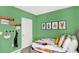 Bright bedroom features a playful decor, green wall color, and ample space for creative activities at 3633 Salvia Ct, Tavares, FL 32778
