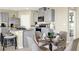Kitchen and dining area with gray cabinetry, stainless steel appliances, and granite countertops at 3633 Salvia Ct, Tavares, FL 32778