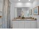 Bathroom featuring double sinks, granite countertops, and decorative elements at 3893 Diving Dove Ln, Bartow, FL 33830