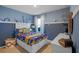 Charming bedroom with blue walls, white trim, carpet flooring, and nautical decor at 3893 Diving Dove Ln, Bartow, FL 33830