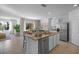 Bright and open kitchen featuring a large island, stainless steel appliances, and ample counter space at 3893 Diving Dove Ln, Bartow, FL 33830