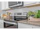 Modern kitchen features granite countertops and stainless steel oven and microwave at 3893 Diving Dove Ln, Bartow, FL 33830