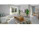 Bright and airy living room with comfortable seating, large window, and stylish decor at 3893 Diving Dove Ln, Bartow, FL 33830