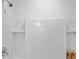 Clean white tiled shower with modern fixtures and built-in shelving at 3893 Diving Dove Ln, Bartow, FL 33830