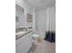 Bright bathroom with a granite countertop vanity and a shower-tub combination with modern fixtures at 3901 Diving Dove Ln, Bartow, FL 33830