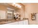 Bright bathroom features a double sink vanity with granite countertop and white cabinets at 3965 Kennebunk Loop, Mount Dora, FL 32757