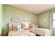 Bright bedroom features two twin beds with mermaid-themed decor and a large window at 3965 Kennebunk Loop, Mount Dora, FL 32757