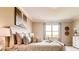 Bedroom features a neutral color scheme, large window with a view, and a decorative headboard at 3965 Kennebunk Loop, Mount Dora, FL 32757