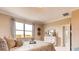 Bedroom with neutral tones, a large window, and a dresser with decorative items at 3965 Kennebunk Loop, Mount Dora, FL 32757