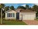 Charming single-Gathering home with brick driveway, stone accents and attached two-car garage at 3965 Kennebunk Loop, Mount Dora, FL 32757
