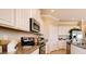 Beautiful kitchen features stainless steel appliances, granite countertops, and modern white cabinetry at 3965 Kennebunk Loop, Mount Dora, FL 32757