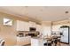 Bright eat-in kitchen with granite counters, stainless appliances, white cabinetry and seating at island at 3965 Kennebunk Loop, Mount Dora, FL 32757