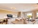 Open-concept living room with granite counter top, island, and seamless access to outdoor views at 3965 Kennebunk Loop, Mount Dora, FL 32757