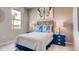 Cozy bedroom decorated with blue accents, featuring ample natural light and stylish furnishings at 3971 Kennebunk Loop, Mount Dora, FL 32757