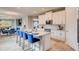 Stylish kitchen features a large island with seating, stainless steel appliances, and white cabinetry at 3971 Kennebunk Loop, Mount Dora, FL 32757