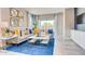 Cozy living room with stylish decor, comfortable seating, and sliding glass doors to the outdoor area at 3971 Kennebunk Loop, Mount Dora, FL 32757
