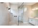 Bathroom featuring a walk-in shower with a bench, dual vanities, and modern finishes, creating a spa-like experience at 4197 Barbuda Ln, Kissimmee, FL 34758