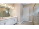 Bathroom showcasing dual vanities, a walk-in shower, and modern fixtures for a luxurious experience at 4197 Barbuda Ln, Kissimmee, FL 34758