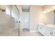Bathroom featuring a walk-in shower, dual vanities, and modern finishes, creating a spa-like experience at 4197 Barbuda Ln, Kissimmee, FL 34758