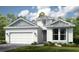 New construction, single-story home with two-car garage and tidy landscaping at 4197 Barbuda Ln, Kissimmee, FL 34758