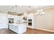 Elegant kitchen featuring white cabinets, stainless steel appliances, a center island, and stylish pendant lighting at 4197 Barbuda Ln, Kissimmee, FL 34758