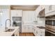 Bright kitchen featuring stainless steel appliances, white cabinets, and a center island at 4197 Barbuda Ln, Kissimmee, FL 34758
