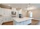 Spacious kitchen with white cabinets, stainless steel appliances, and center island at 4197 Barbuda Ln, Kissimmee, FL 34758