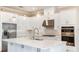 Bright kitchen featuring stainless steel appliances, white cabinets, and a center island at 4197 Barbuda Ln, Kissimmee, FL 34758