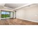 Spacious living room featuring neutral walls, wood-look tile flooring, and sliding glass doors leading to outdoor area at 4197 Barbuda Ln, Kissimmee, FL 34758