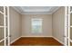 Well-lit home office showcasing stylish flooring, neutral wall paint, and a window for natural light at 4197 Barbuda Ln, Kissimmee, FL 34758