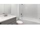 Modern bathroom featuring a combination tub and shower with white subway tile surround and vanity at 4203 Barbuda Ln, Kissimmee, FL 34758