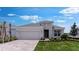 Beautiful single-story home featuring manicured lawn, brick driveway, and an attached two-car garage at 4203 Barbuda Ln, Kissimmee, FL 34758