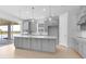 Bright kitchen with a spacious center island, stainless steel appliances, and sliding glass doors at 4203 Barbuda Ln, Kissimmee, FL 34758