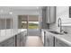 Light and airy kitchen features gray cabinets, stainless steel appliances, and backyard views at 4203 Barbuda Ln, Kissimmee, FL 34758