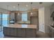 Modern kitchen featuring gray cabinets, a center island with quartz countertop and stainless steel appliances at 4203 Barbuda Ln, Kissimmee, FL 34758