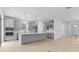 Modern kitchen with gray cabinets, stainless steel appliances, a large island and wood-look floors at 4203 Barbuda Ln, Kissimmee, FL 34758