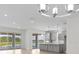 Open-concept living area with elegant lighting, a seamless flow into the kitchen and access to a beautiful outdoor view at 4203 Barbuda Ln, Kissimmee, FL 34758