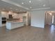 Open-concept living space with white cabinets, spacious island, stainless steel appliances, and recessed lighting at 4203 Barbuda Ln, Kissimmee, FL 34758