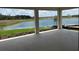 Covered patio area offering serene lake views, perfect for outdoor relaxation and entertaining at 4203 Barbuda Ln, Kissimmee, FL 34758