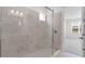 Bright bathroom featuring a spacious shower with large tile and a glass enclosure, complemented by natural light at 4203 Barbuda Ln, Kissimmee, FL 34758